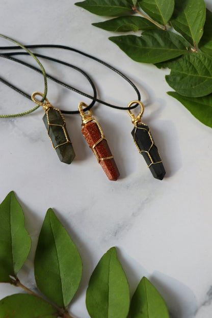 A photo of several classic hex pendants laying together on a table