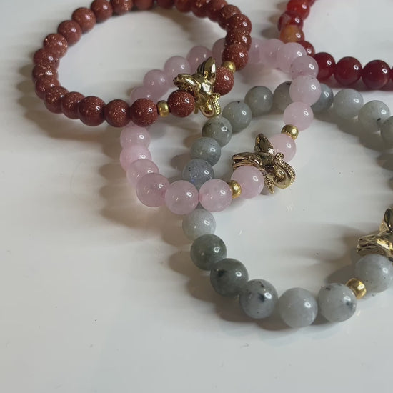 A video of several elephant bracelets on a table