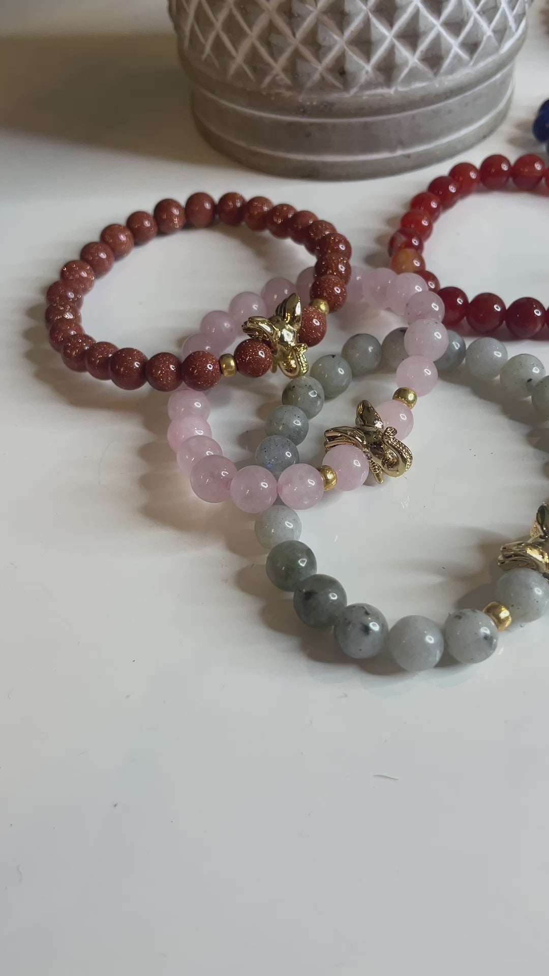 A video of several elephant bracelets on a table