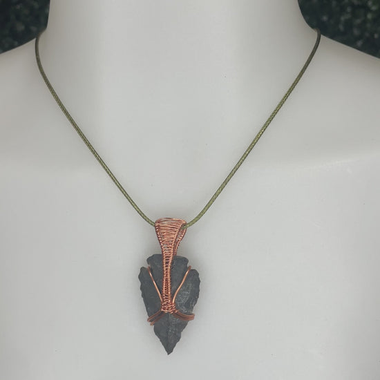 A video of an arrowhead pendant on a mannequin's neck