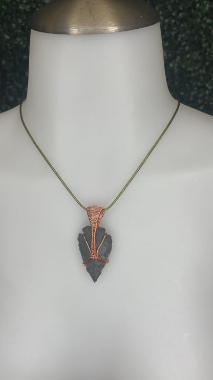 A video of an arrowhead pendant on a mannequin's neck